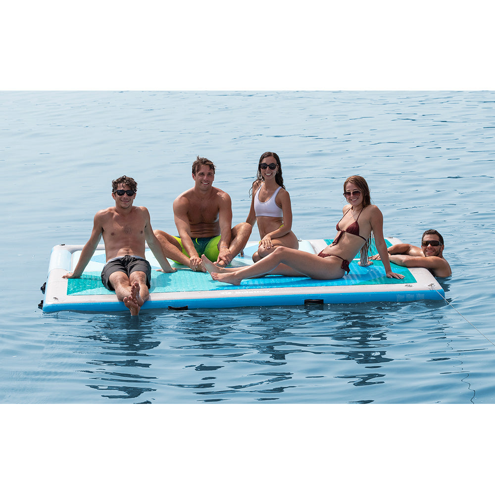 Group of friends lounging on a Solstice inflatable water platform, floating dock for lake and sandbar 