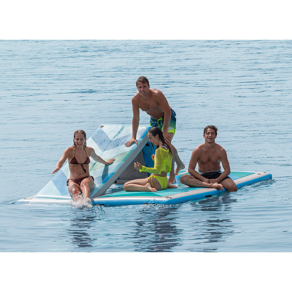 “Family and friends playing on a Solstice inflatable water platform with a built-in climbing feature for fun on the lake.”